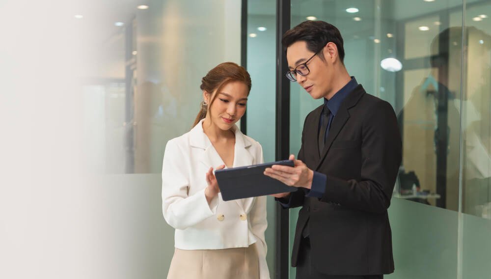 businesswoman showing tablet to her manager